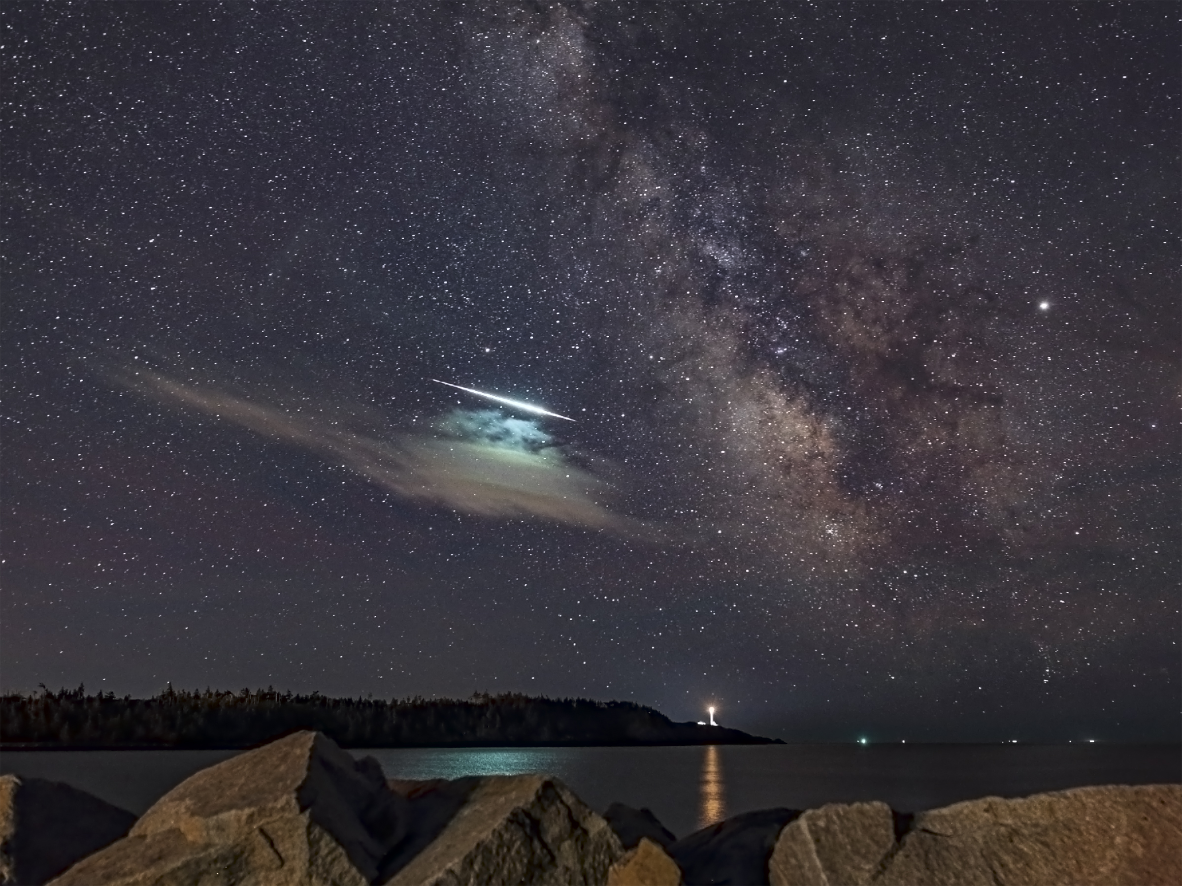 Image Title  - Fireball Meteor  What the object is - Meteor        Pertinent details - unplanned capture! I was shooting the Milky Way and the meteor photobombed the shot. It appears to have travelled horizontally above a cloud, which gives a helicopter effect. The green colour was pretty intense.   Location - Outer False Harbour near Cape Forchu lighthouse, Yarmouth County, NS  Time - July 2, 2019 at approximately 12:39:28 AM; my camera clock settings were "off" so I tried to correct the data by using a universal time clock.    Camera - Canon 6D  Settings - 20.0 seconds exposure, F/2.0. ISO 1600.  Lens - Sigma 20mm F/1.4 DG HSM Art on a Canon mount  Tripod, no tracker used  Processed in Photoshop CC from TIFF file with basic adjustments to brightness, contrast, shadows, dehaze, colour balance, luminance, saturation, noise and so on. Cropped to required size. 